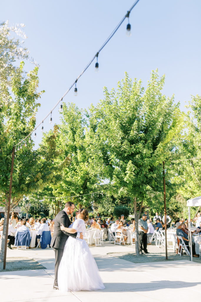 bride and groom dancing at wedding reception at the gardens venue in tulare california