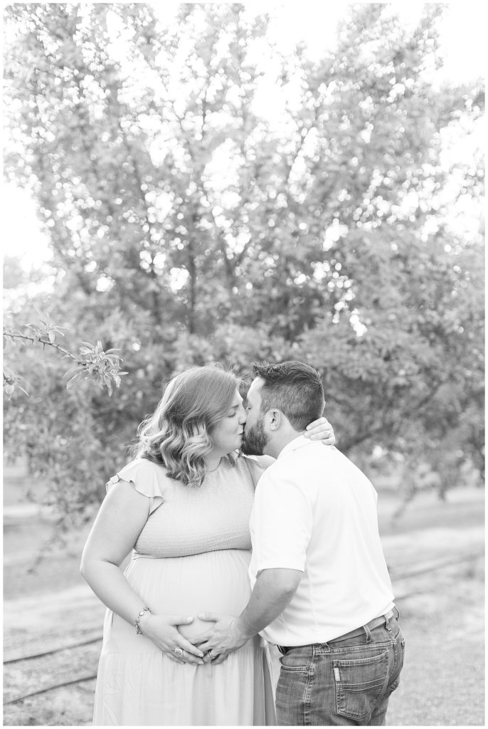 black and white photo of husband and wife kissing
