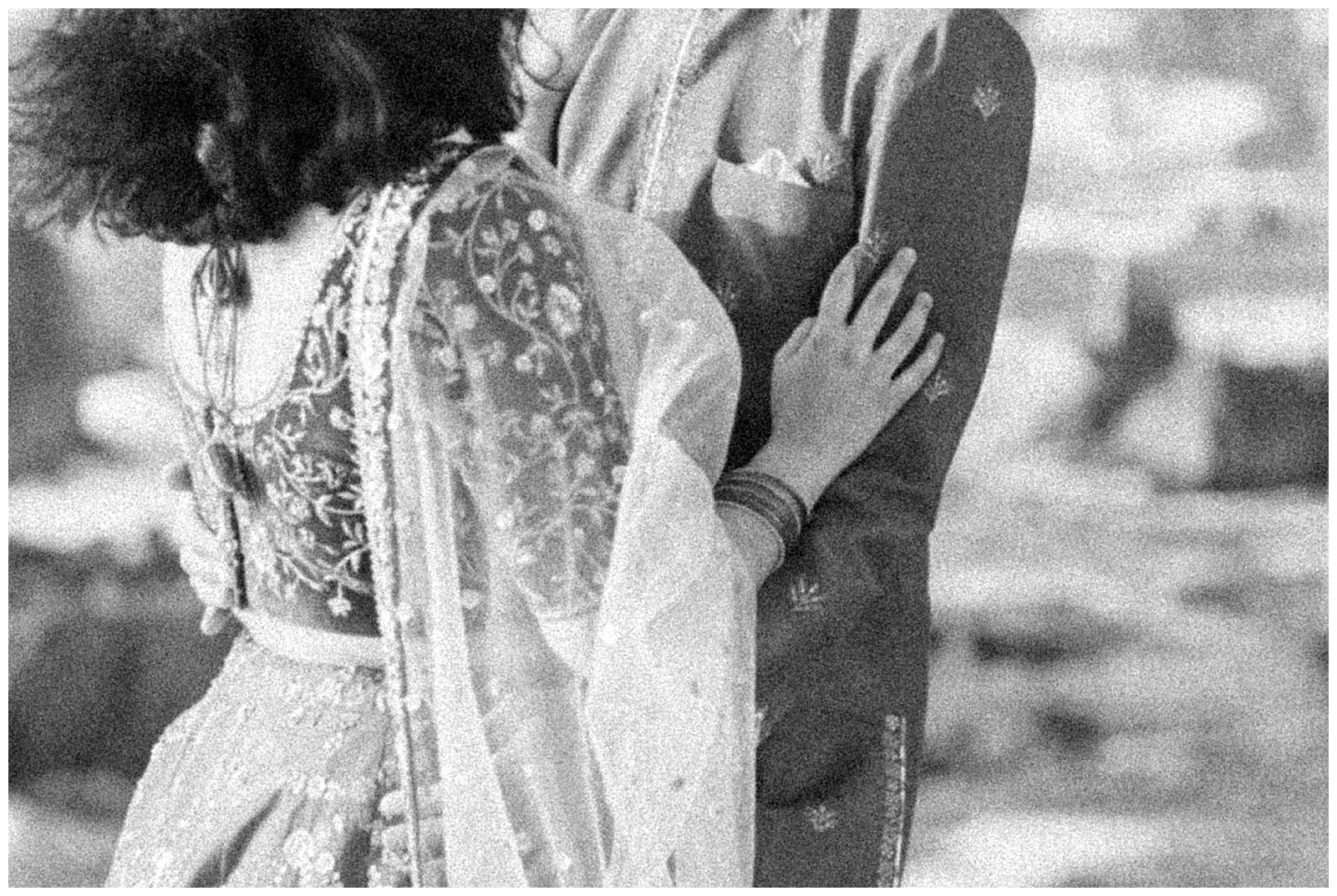 close up black and white grainy film inspired image bride and groom indian attire carmel-by-the-sea