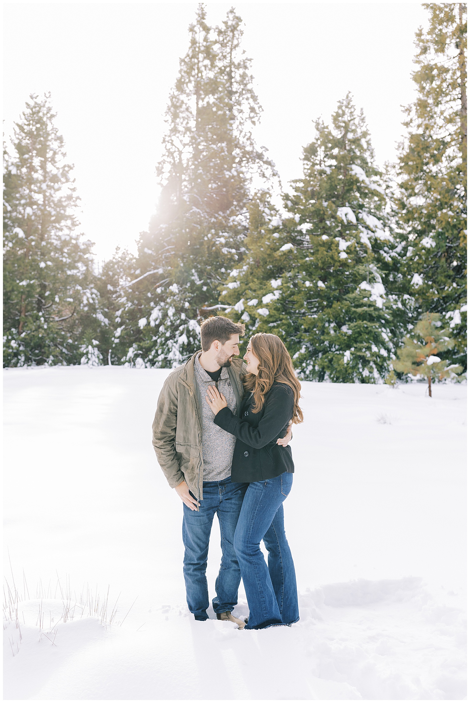 engaged couple embracing in the snow