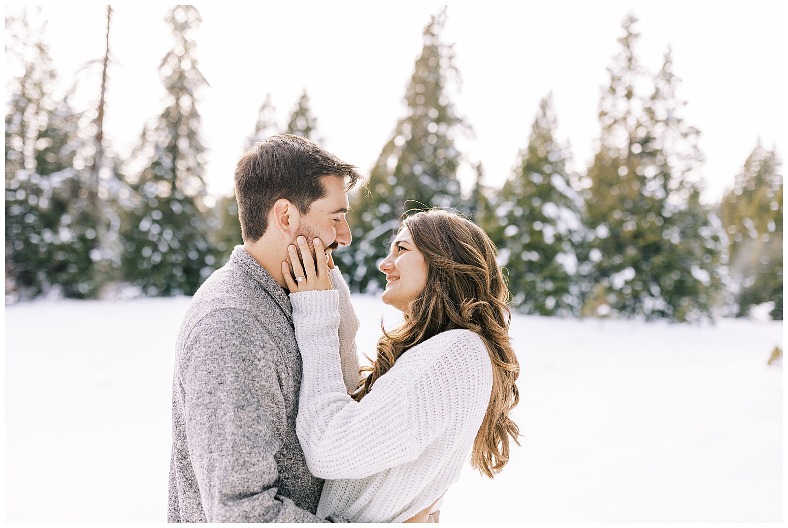 engaged couple embracing almost kissing in snow fresno wedding photographer megan helm 