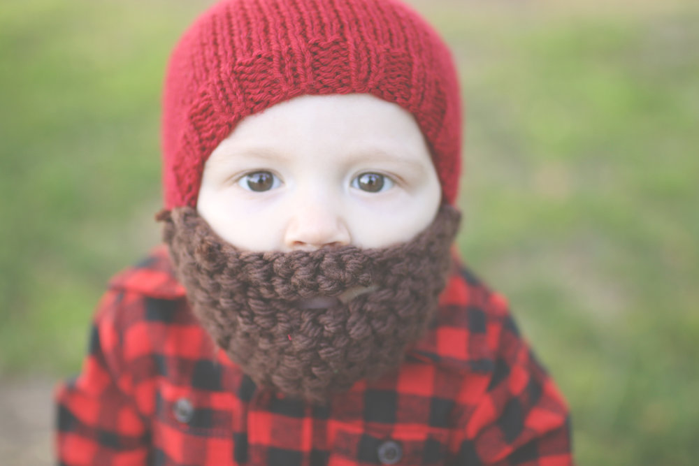 young boy wearing a lumberjack crochet beanie and beard