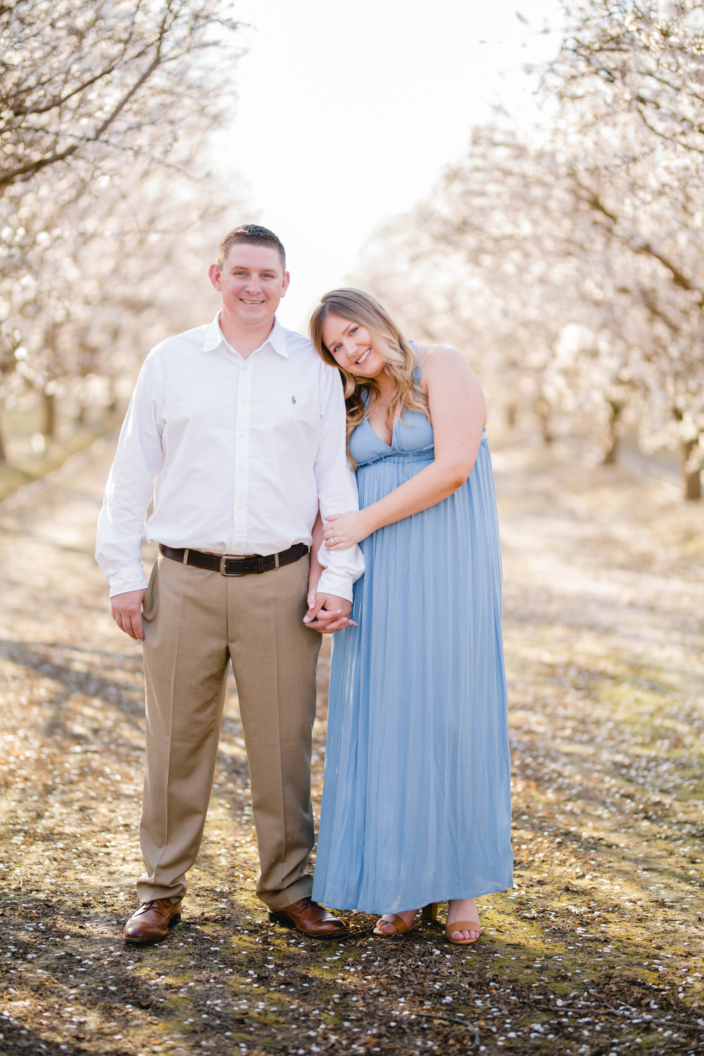 blue and white engagement photo ideas in almond blossoms