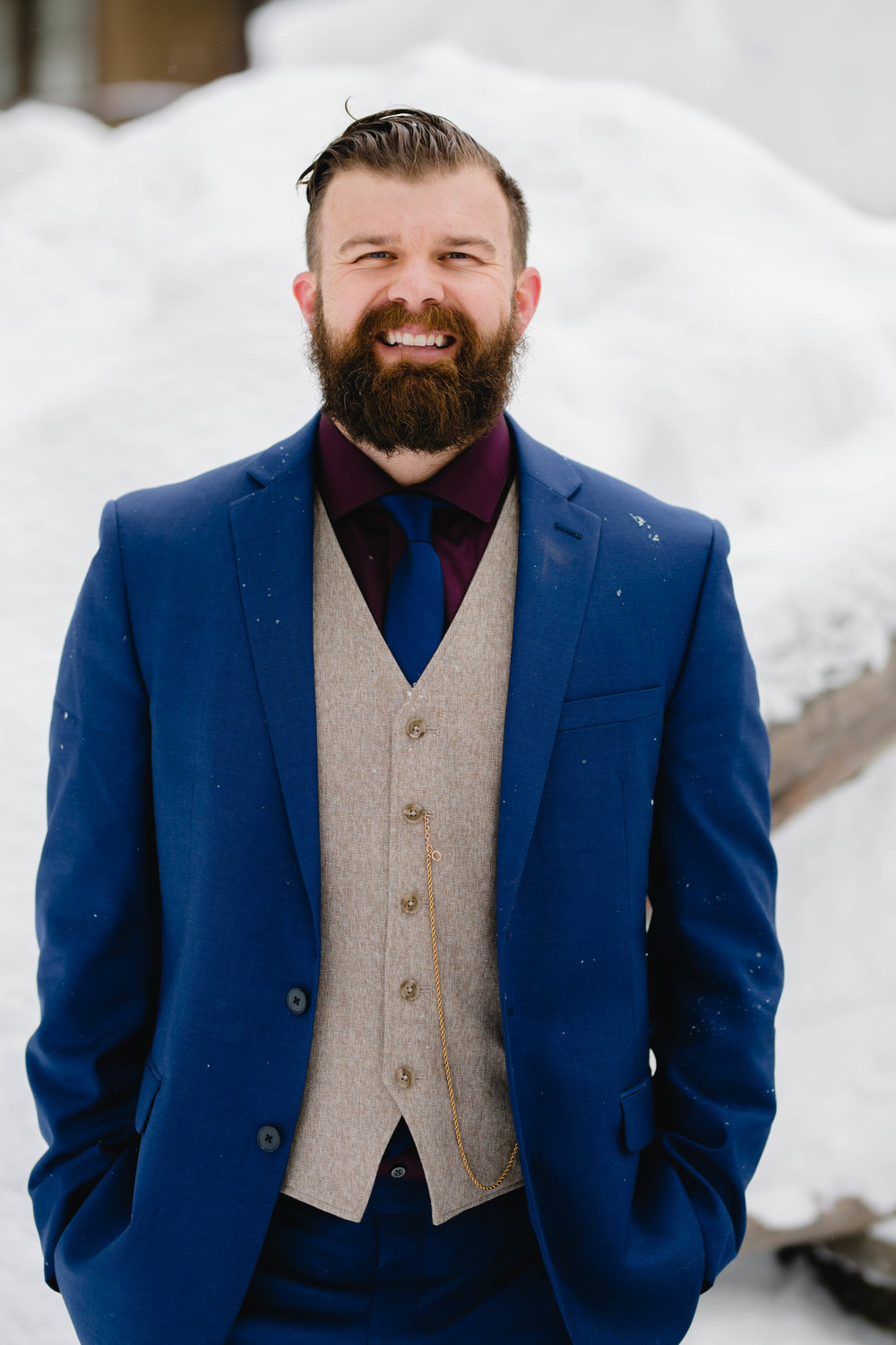 wedding portrait of the groom in a navy blue suit
