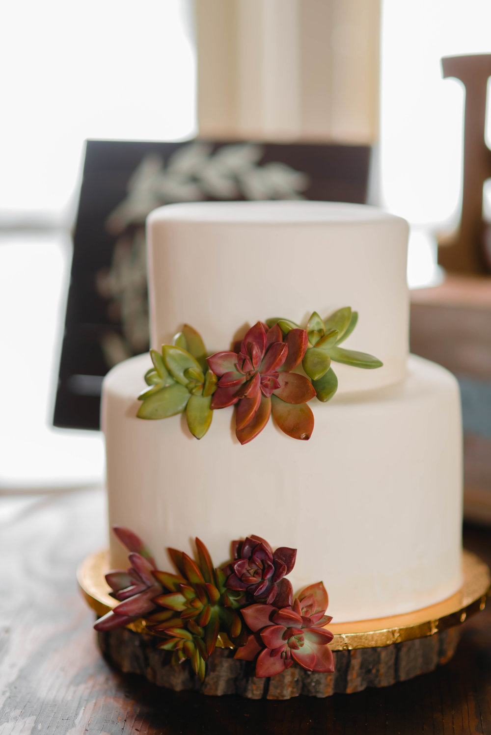 white wedding cake with succulents