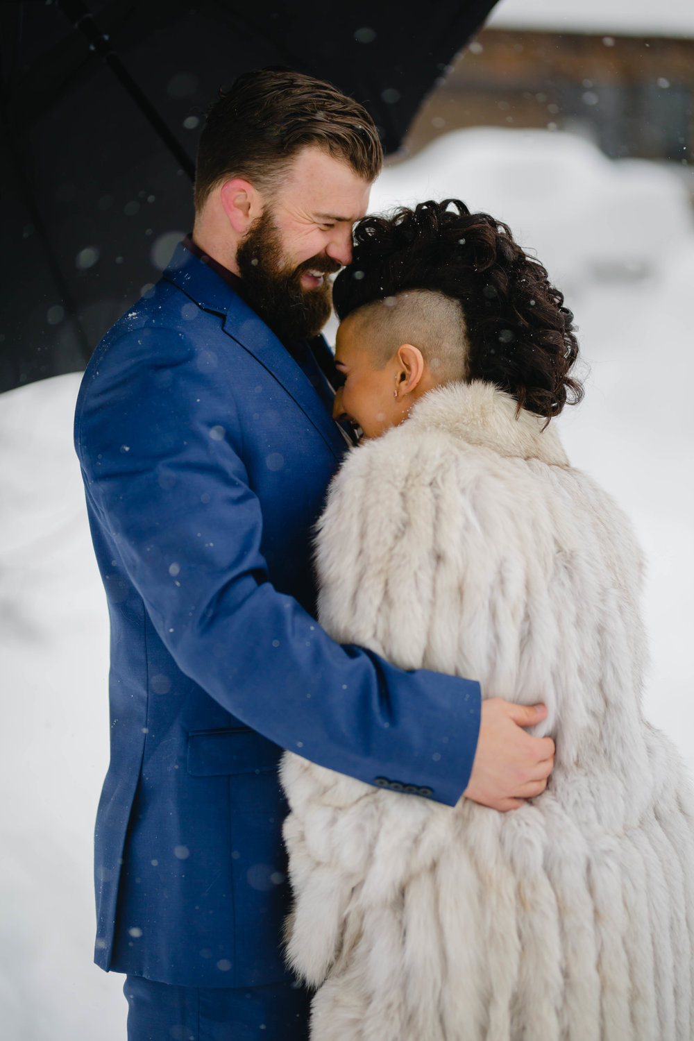 candid photo of the bride and groom on a snowy wedding day
