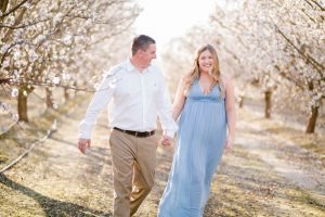 almond blossom engagement photos with blue and white outfits