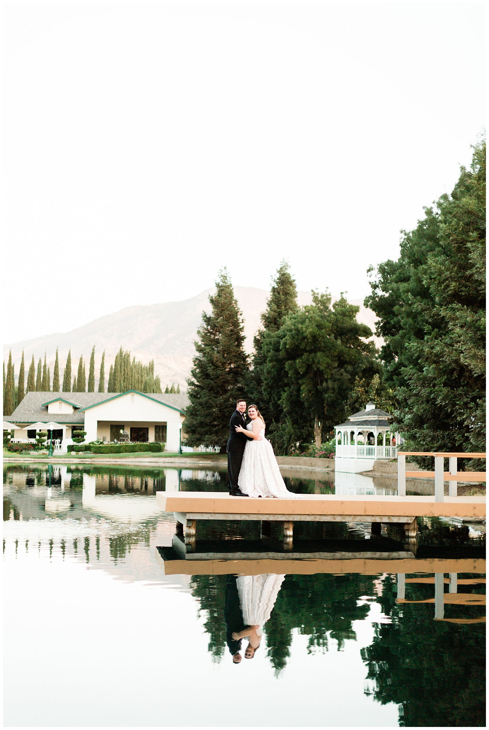 bride and groom on the pier over the water at wonder valley ranch a fresno wedding venue
