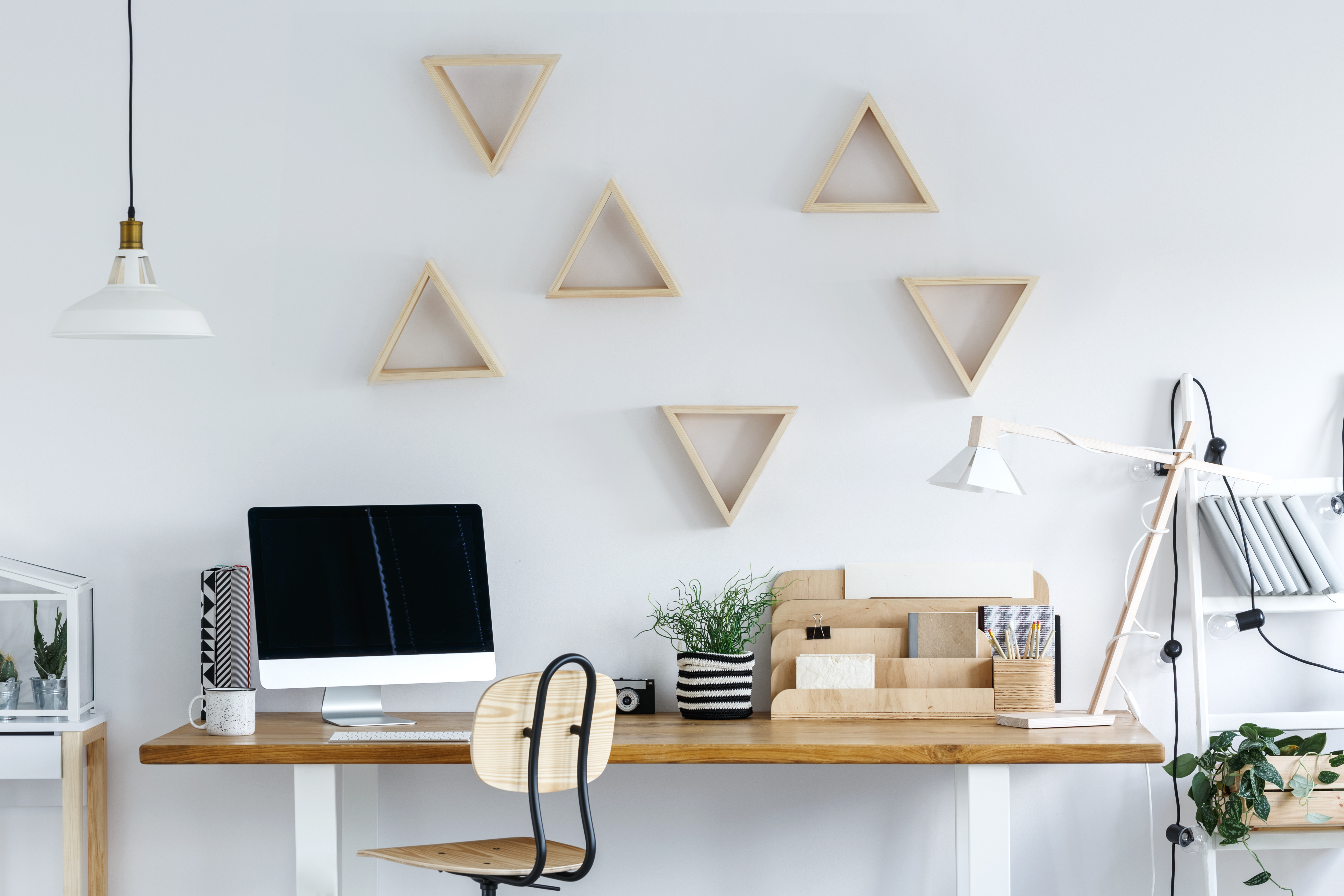 wooden desk with geometric wall decor