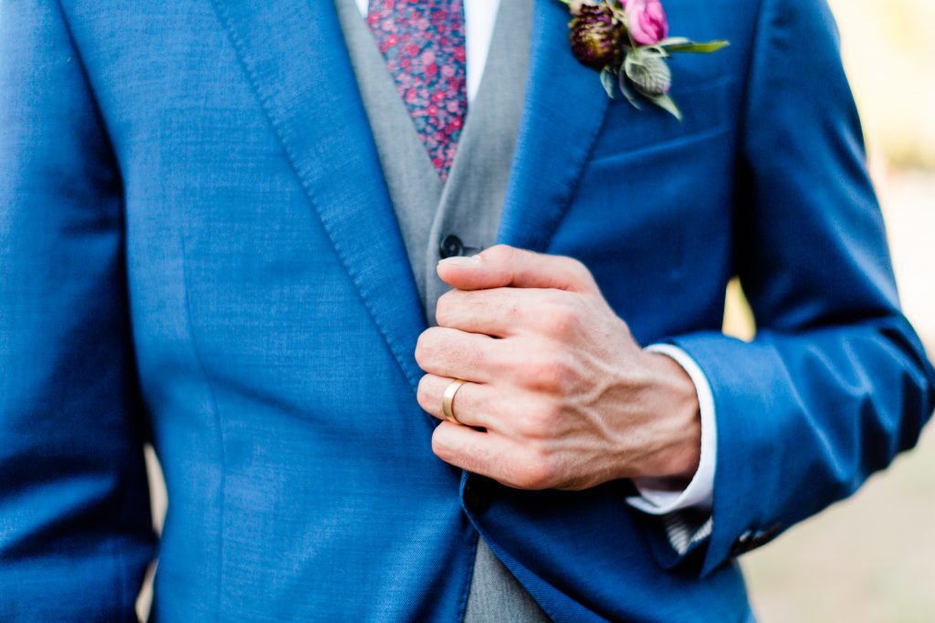 navy suit and gold wedding ring