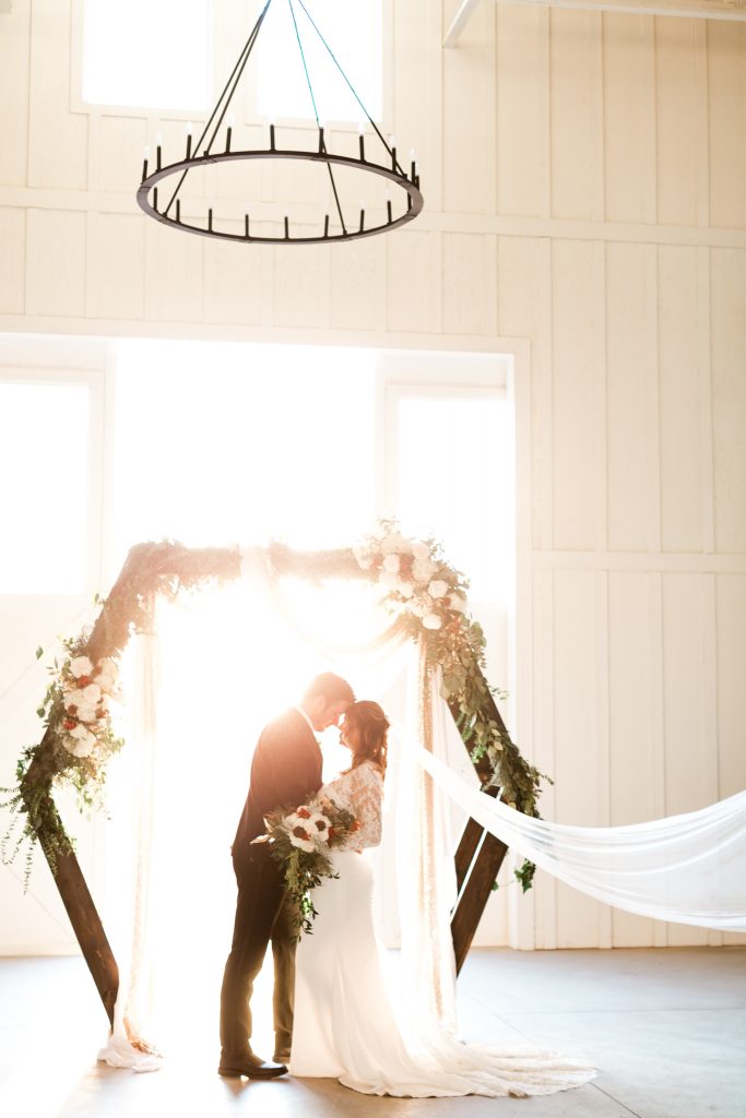 Geometric arbor for an indoor sunset wedding ceremony