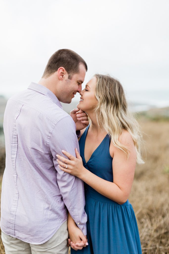 engaged couple on the cliffs of the california coast