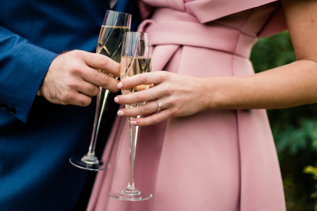 engaged couple cheersing champagne glasses
