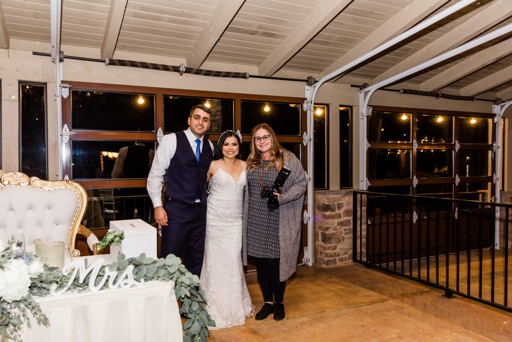 bride and groom with wedding photographer at reception at Wolf Lakes Park