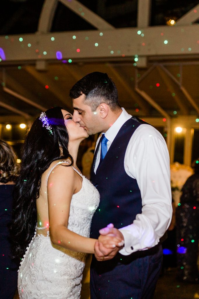 kissing in the disco lights at reception