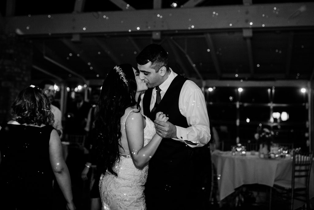 black and white kissing during reception dance party