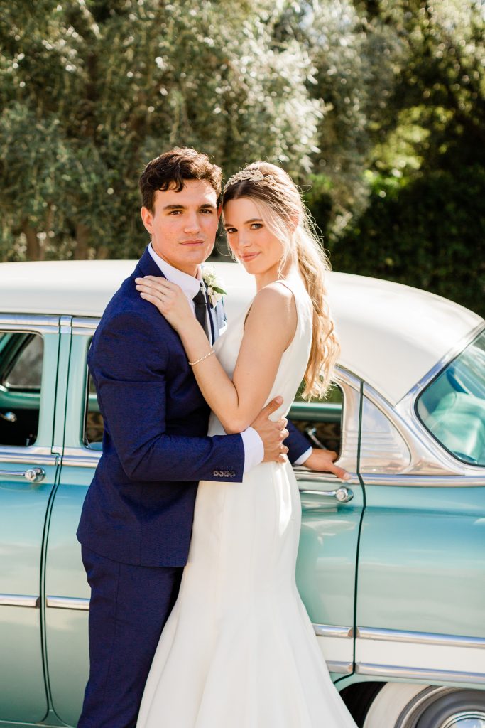 stoic couple portrait in front of vintage car