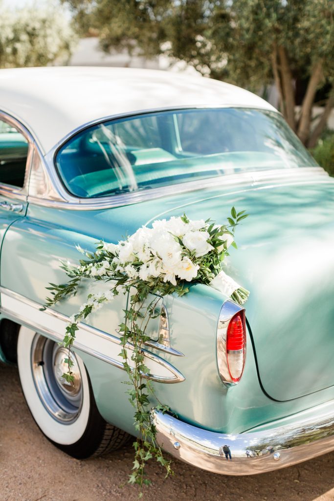 teal vintage car with white bridal bouquet 