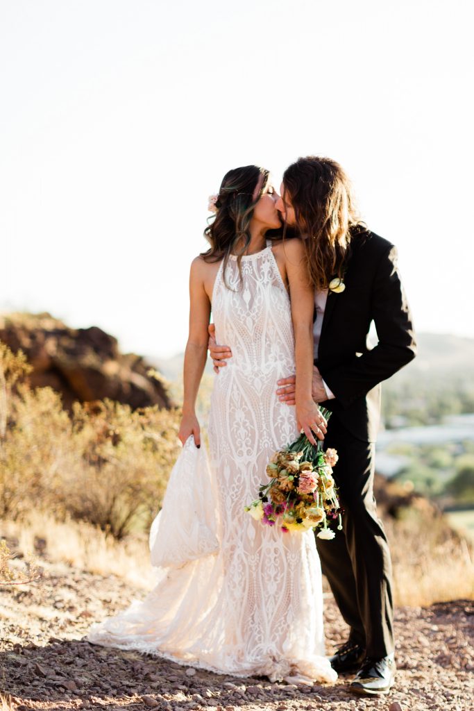 married couple kissing on the cliffs in tempe arizona desert