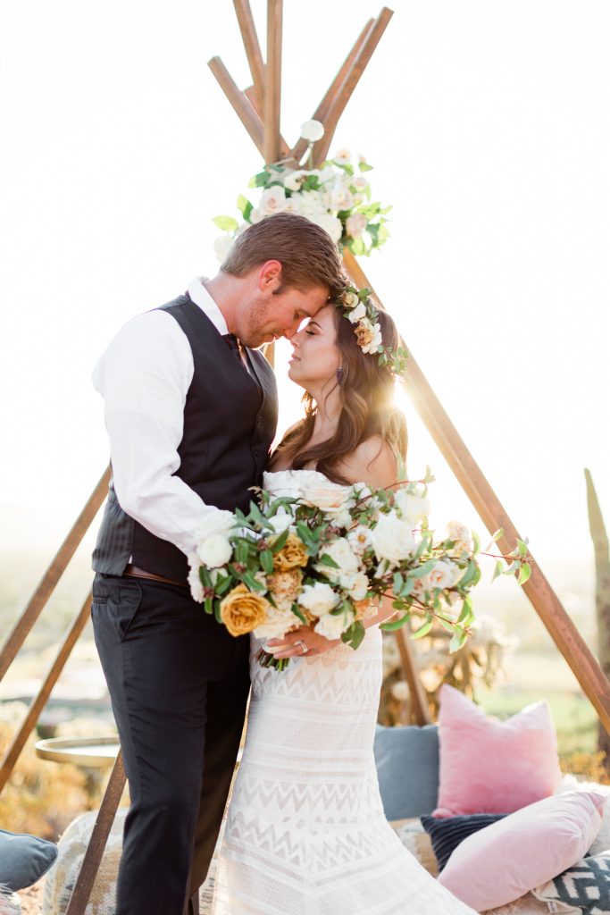 wedding/elopement photo with aframe and neutral flowers