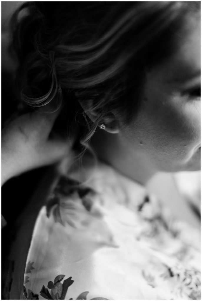 detail photo of brides earring and hair