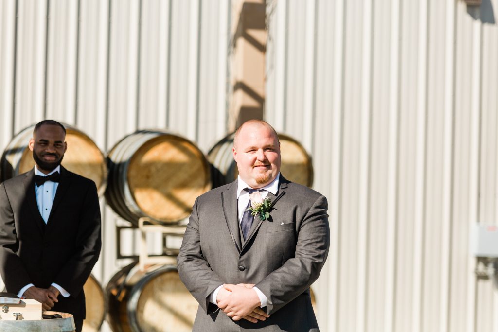 groom and officiant waiting at ceremony