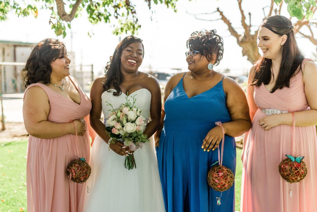 bride with bridesmaids in blue and pink