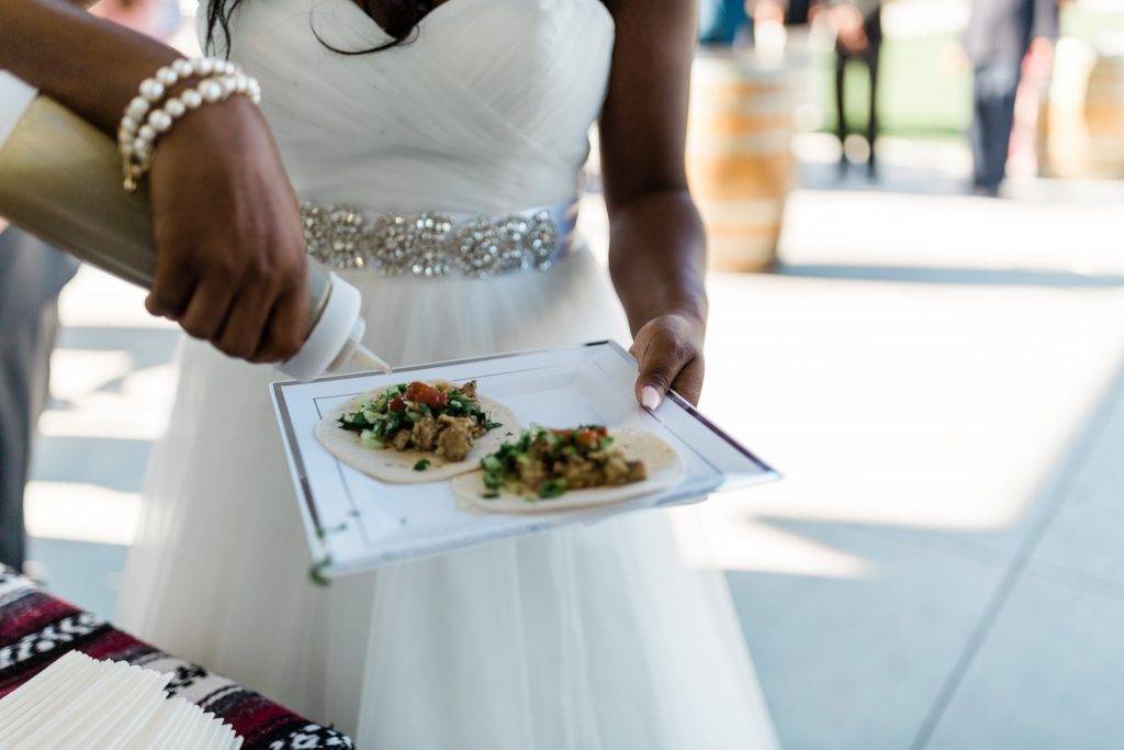 bride making tacos during cocktail hour