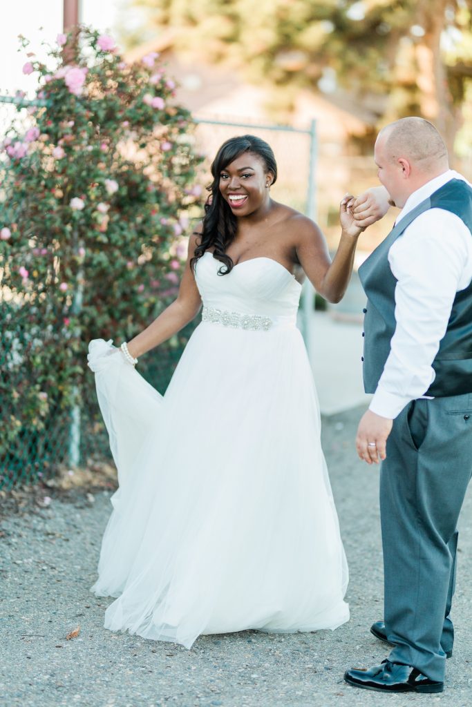 groom twirling bride in her strapless wedding dress