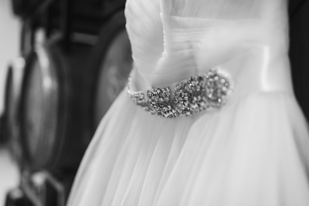 black and white photo close up of beaded wedding dress belt
