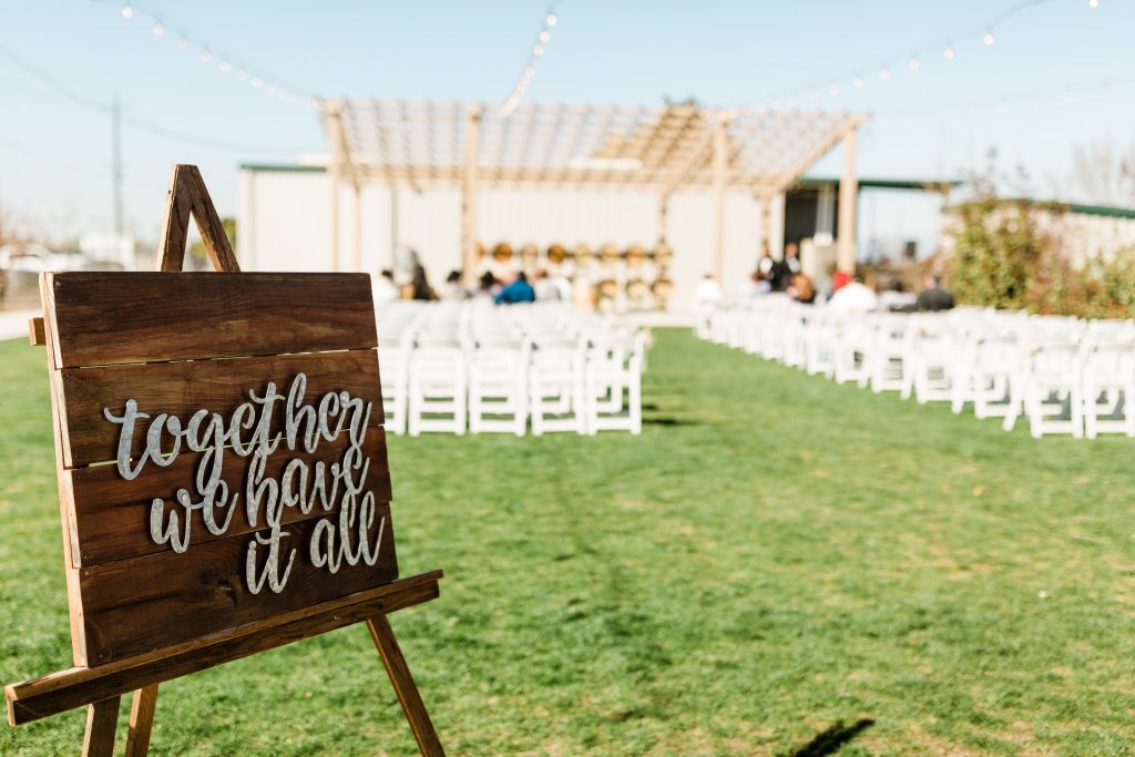 "together we have it all" wooden sign at Kings River Winery wedding
