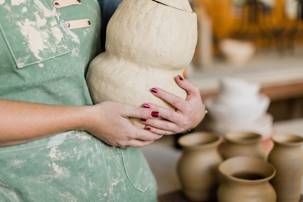 close up of custom clay pottery being held by maker