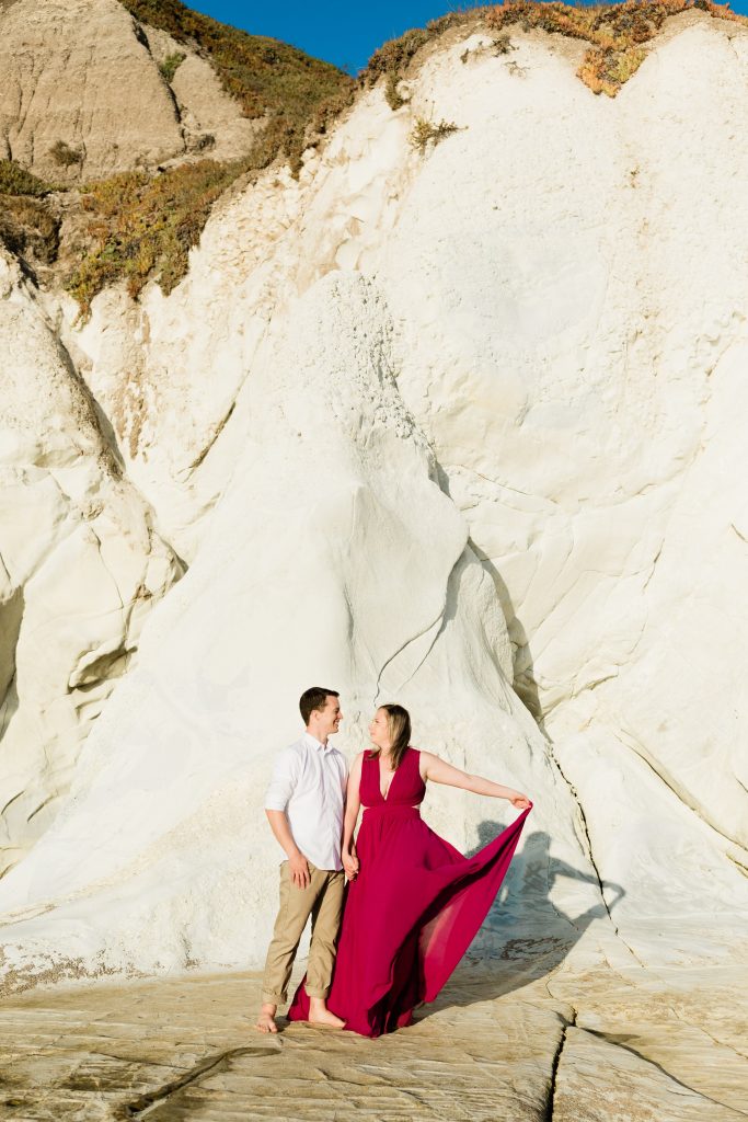 engaged couple standing on the cliffs of pismo beach