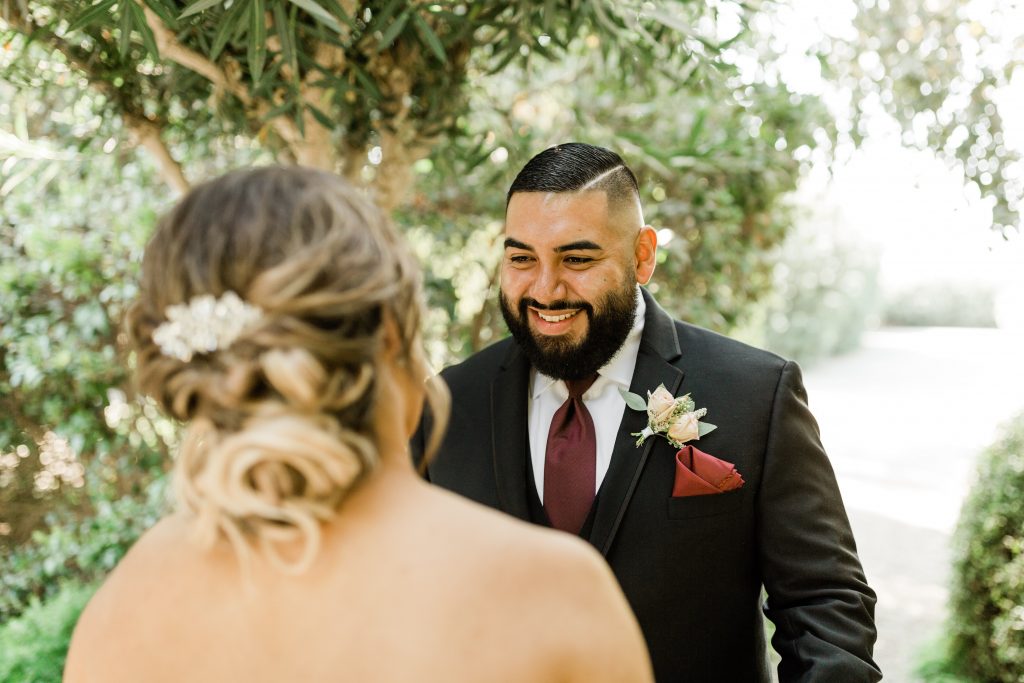 groom smiling at his bride after seeing her for the first time on their wedding day