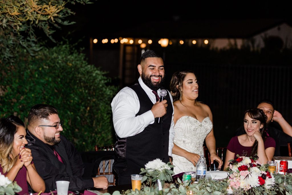 groom smiling during his wedding toast