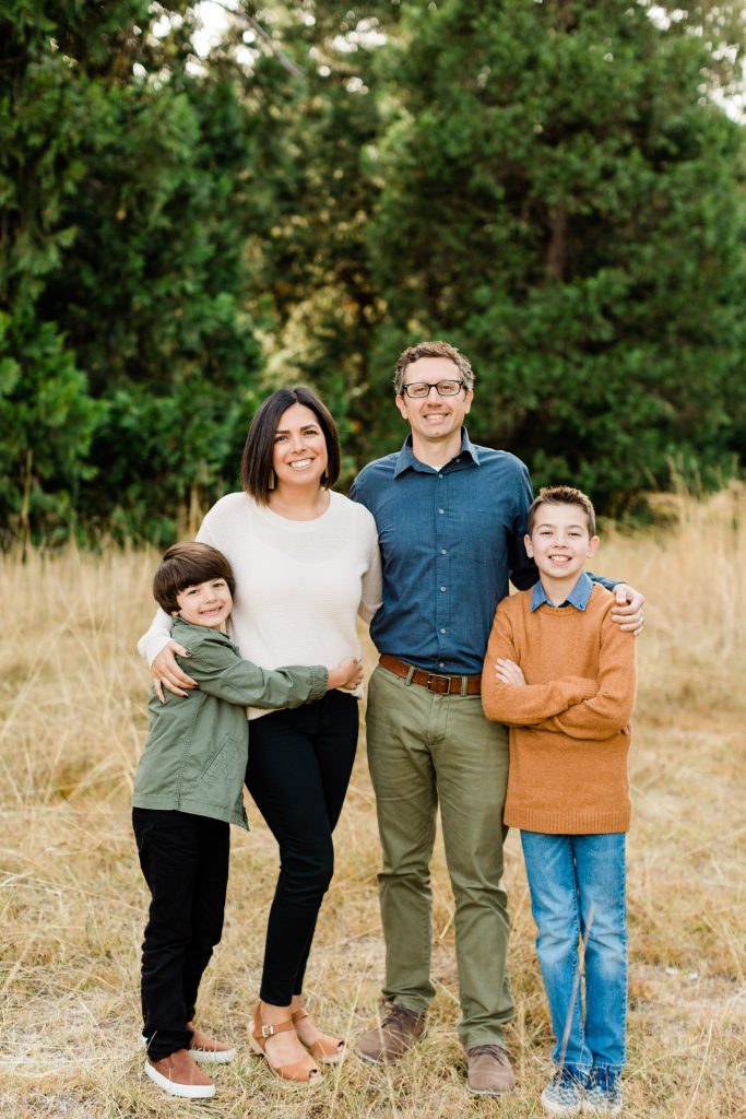 what to wear for fall family photos in a meadow with olive green and burnt orange outfits