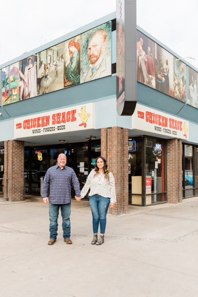 couple holding hands in front of the chicken shack in fresno california