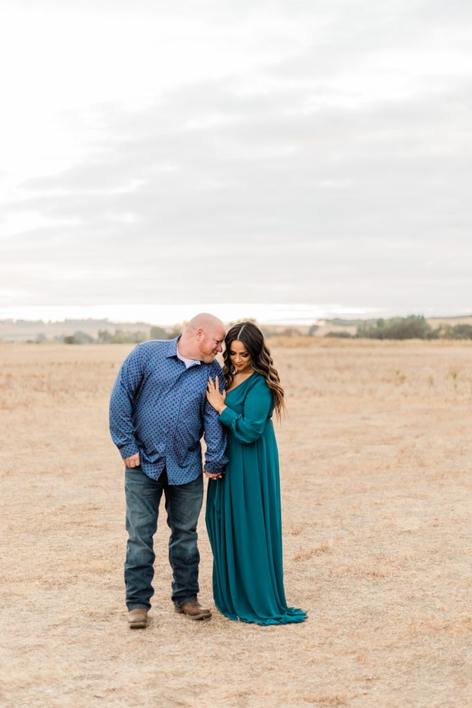 open field engagement photos with blue maxi dress