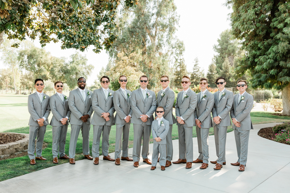 Groomsmen in a line in light grey suits