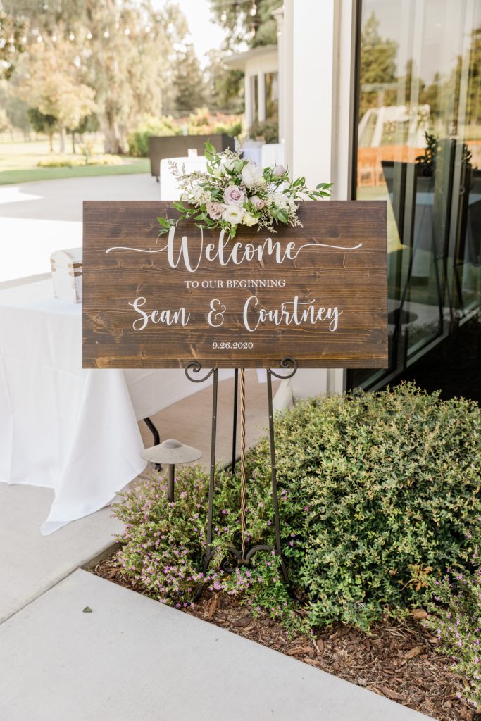 Wooden rustic wedding welcome sign at country club wedding