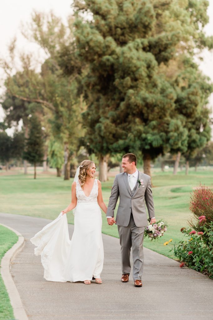 Newlyweds walking down path at Sunnyside Country Club wedding