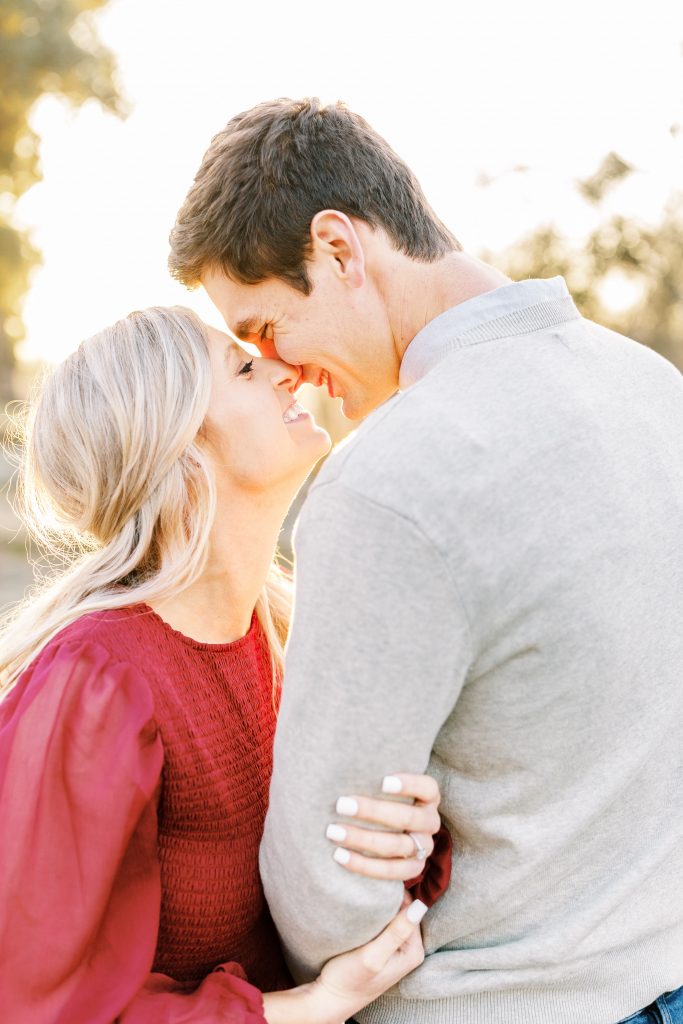 couple leaning in to kiss during fall engagement photos