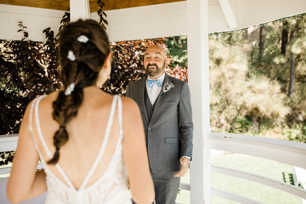Groom with face of surprise at first look of bride in her dress