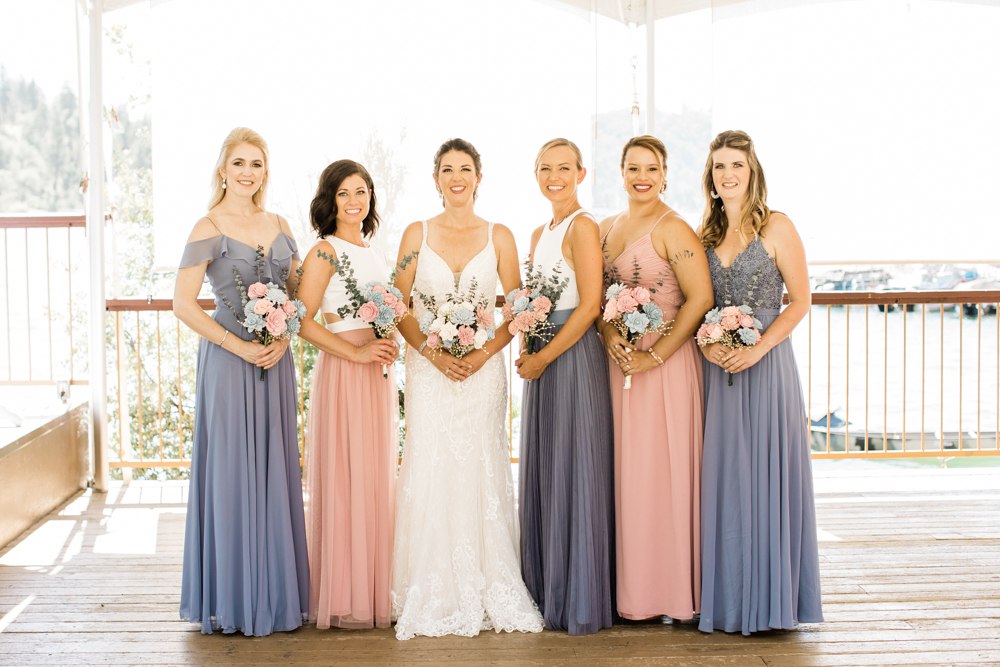 Bridesmaids in blush and dusty blue at the Pines resort for a wedding in Bass Lake, Ca.