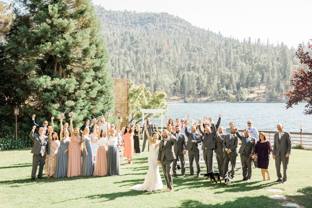 Entire wedding guest group cheering after Bass Lake wedding ceremony