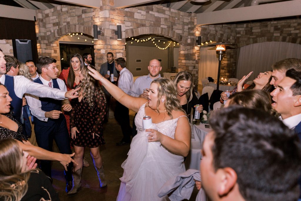 Bride being the life of the party during wedding reception at Wolf Lakes Park