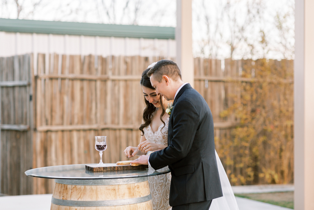 Bride and Groom partaking in communion at a Kings River Winery wedding ceremony