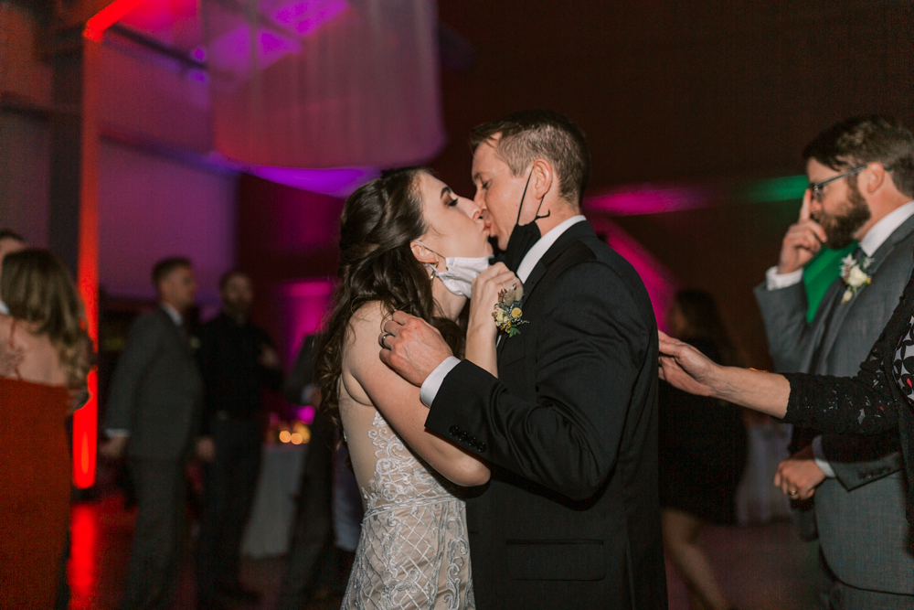 Newlyweds kissing while dancing at a Kings River Winery wedding reception