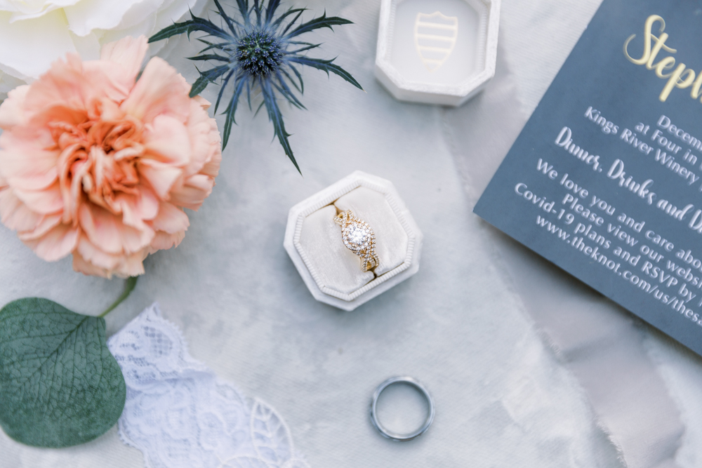 Brides gold ring with round cut diamond and halo in a white Mrs Box. 