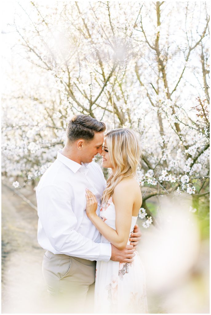 Couple in love during spring engagement photos in the trees